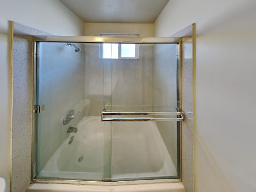 a shower with a glass door in a bathroom at San Jose Apartment in San Jose