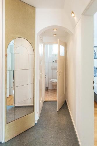 an empty hallway with a mirror and a bathroom at Sea Rose in Friedrichshafen