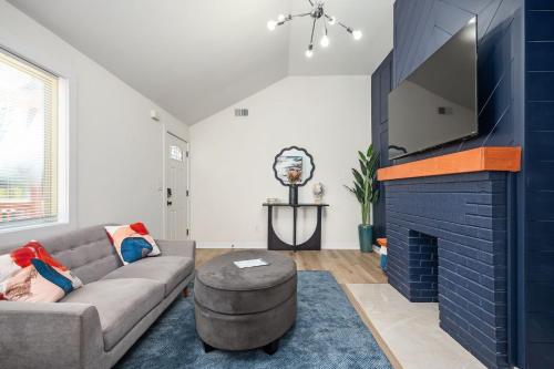 a living room with a couch and a fireplace at Relax in a Modern Luxury 1BD in Sylvan Hills in Atlanta