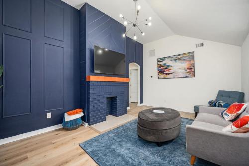a living room with a couch and a fireplace at Relax in a Modern Luxury 1BD in Sylvan Hills in Atlanta