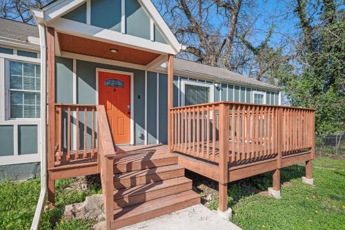 a tiny house with a large wooden deck at Relax in a Modern Luxury 1BD in Sylvan Hills in Atlanta