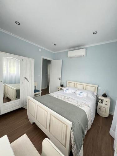 a bedroom with a large bed and a mirror at Casa Santa Rita in Alcobaça
