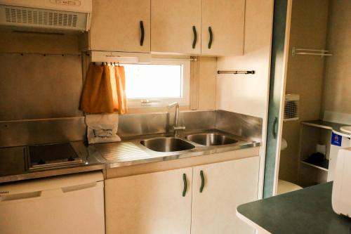 a small kitchen with a sink and a window at Camping Castillo de Loarre in Loarre
