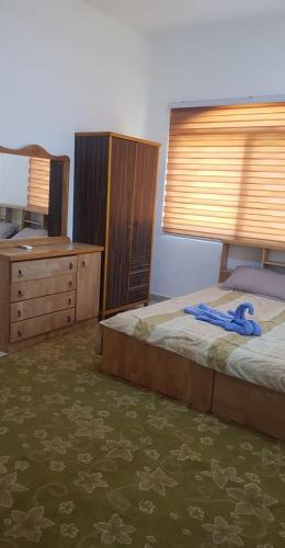 a bedroom with a bed with a blue ribbon on it at Golden hotel in Jerash