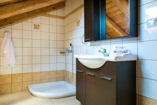 a bathroom with a sink and a toilet at 1841 Petrino Villa in Fiskardho