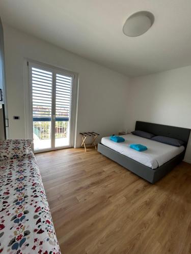 una camera da letto con un letto e una grande finestra di La Finestra Blu Alba 1 ad Alba