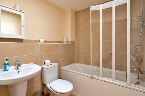 a bathroom with a toilet and a sink and a shower at Finest Retreats - Hardie Close in Tetbury