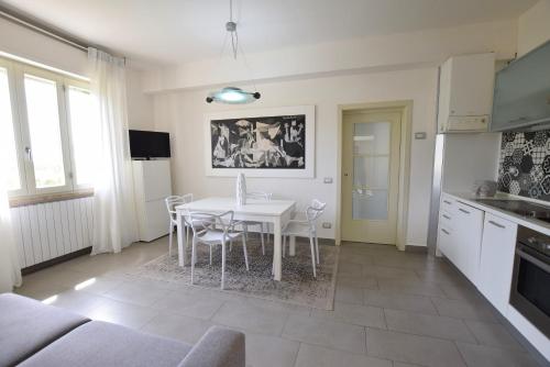 a kitchen and dining room with a table and chairs at Marco' s apartment in San Vincenzo