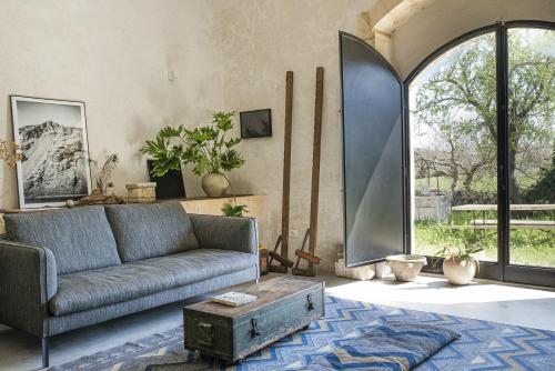 a living room with a couch and a large window at Casa Balat in Noto