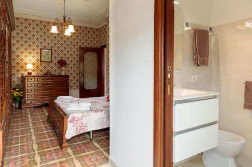 a bathroom with a bed and a sink and a mirror at Casa vacanze GEMMA in Agropoli