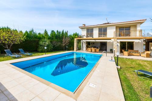 a swimming pool in front of a house at Villa Anassa Private Pool Near Beach in Paphos