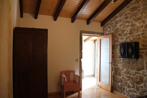 a room with a door and a room with a chair at Casa Maria da Assunção in Vila Nova de Cerveira