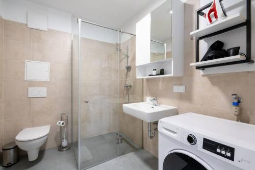a bathroom with a toilet and a sink and a shower at 1BR with Balcony, Urban Style by HM in Vienna