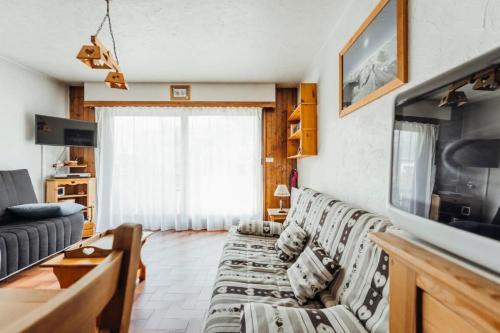 sala de estar con sofá y TV en Bon Nant furnished flat en Saint-Gervais-les-Bains