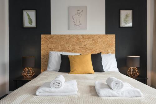 a bedroom with a bed with two towels on it at Superb Beverley 3 Bedroom House with Private Parking and Garden - The Nicholson in Beverley