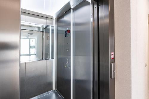 a stainless steel elevator in a building at Apartment "Sonnendeck" - Haffresidenz in Garz-Usedom