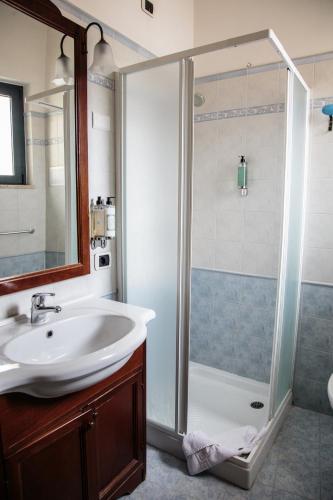 a bathroom with a shower and a sink at Hotel Pina Ristorante in Isola del Gran Sasso dʼItalia