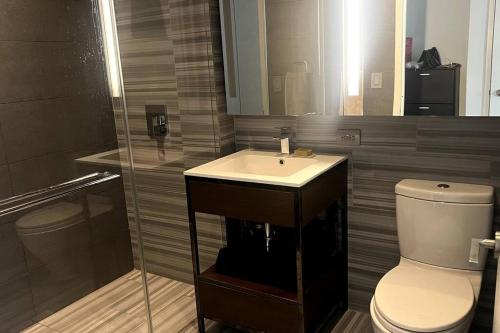 a bathroom with a sink and a toilet at Skyline vie, Luxury, Quiet 1br in New York