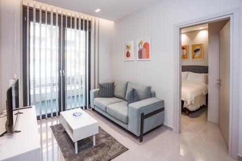 a living room with a couch and a tv and a bed at Urban Apartments in Chios
