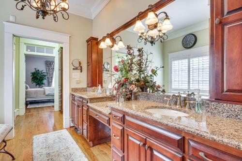 a bathroom with two sinks and a large mirror at Riverfront North Augusta Home with Private Pool! in North Augusta
