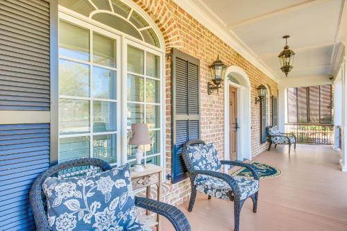 a porch with rocking chairs and windows on a house at Riverfront North Augusta Home with Private Pool! in North Augusta