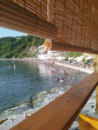 a beach with a bunch of people in the water at Seaside Apartment Kruče in Kruče
