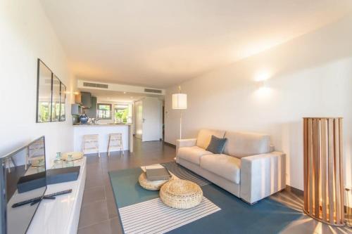 a living room with a couch and a table at Séquoia furnished apartment in Antibes