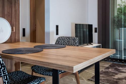 a dining room with a wooden table and chairs at Urban Apartments in Chios