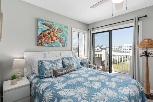 a bedroom with a bed and a large window at Seaside Sunrise Sanctuary in Carolina Beach