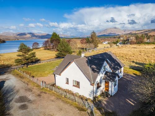 an aerial view of a white house with a fence at Brackenbrae Holiday Cottage in Acharacle