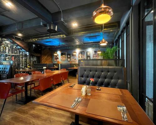 a dining room with wooden tables and chairs at Nights in A Box in Ban Muang (1)