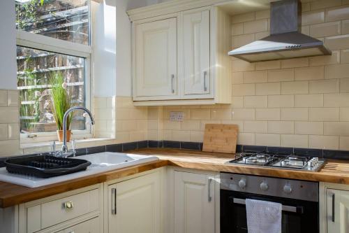 a kitchen with a sink and a stove at West Beck House Newcastle - Spacious Double Room in North Shields