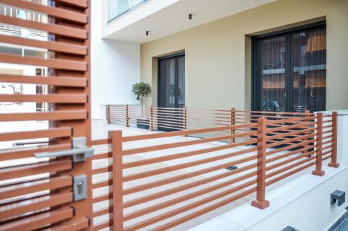 a wooden railing on the balcony of a house at Urban Apartments in Chios