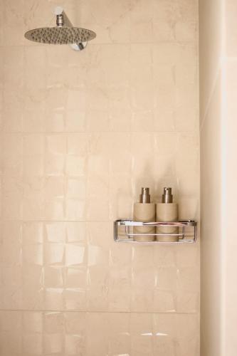 a bathroom with three rolls of toilet paper on a wall at Villa Boa Milos 4 Bedrooms near Adamas in Adamantas