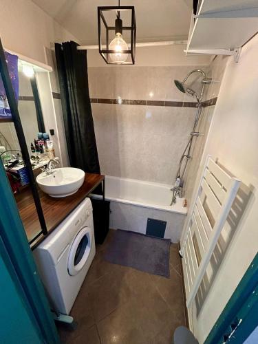 une salle de bain avec un lavabo, une baignoire et des toilettes dans l'établissement Heyzie, à Pontault-Combault