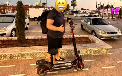 a person with a smiley face on a scooter at Аренда Электросамокатов в Шарм Эль Шейхе in Sharm El Sheikh