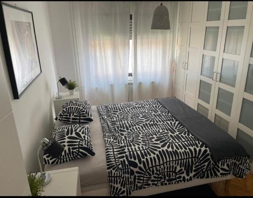a bedroom with a zebra print bed and two pillows at Apartment Blondie Zagreb in Zagreb
