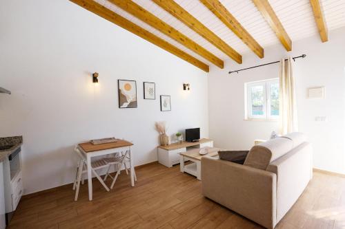 a living room with a couch and a table at I - St. Johns Countryside Getaway in Odiáxere