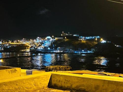 a view of a river at night with a city at Bungalow acogedor cerca a todo in San Bartolo