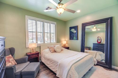 a bedroom with a bed with a ceiling fan and a mirror at Charming Henderson Home 6 Mi to Lake Las Vegas! in Las Vegas