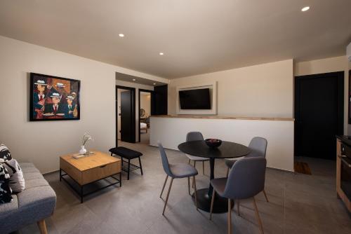 a living room with a table and chairs at Fluvian Terrace in Rhodes Town