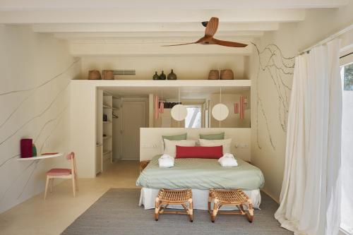 a bedroom with a large bed and two chairs at Hotel Rural Morvedra Nou in Ciutadella