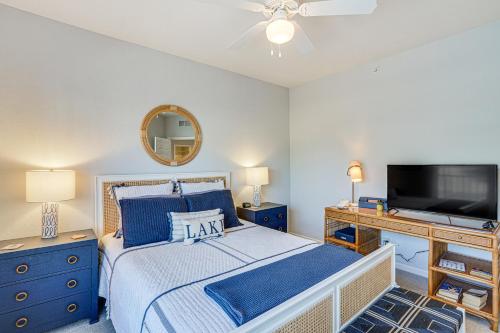 a bedroom with a bed and a flat screen tv at Osage Beach Lakefront Condo with Screened Balcony! in Osage Beach