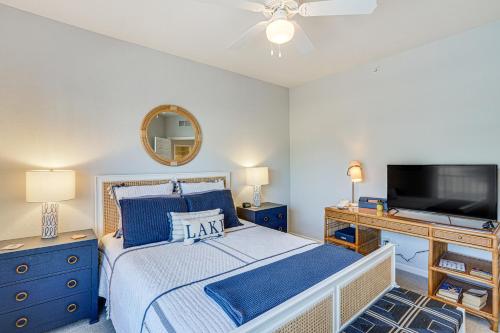a bedroom with a bed and a flat screen tv at Dine Al Fresco on Balcony Osage Beach Condo! in Osage Beach