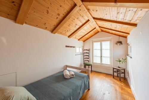 a bedroom with a bed and wooden ceilings at Casa Rita, Charming House with pool, Asti in Asti