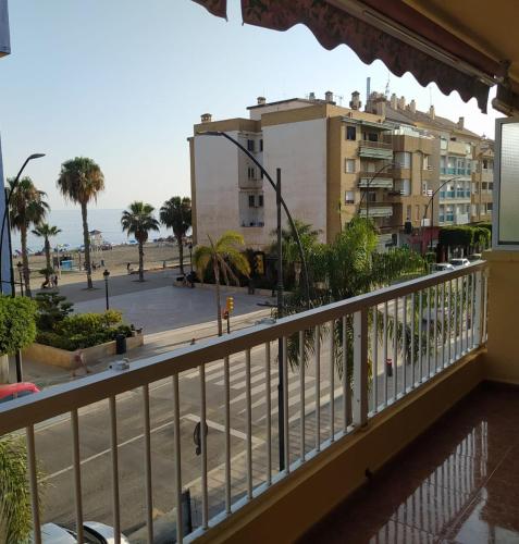 a balcony with a view of a beach and buildings at Nonna Beach Apartment Two-Bedroom Sea Views 50 m from the Beach Wifi in Rincón de la Victoria