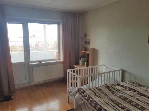 a small bedroom with a bed and a window at Lovely apartment in Riga city in Rīga