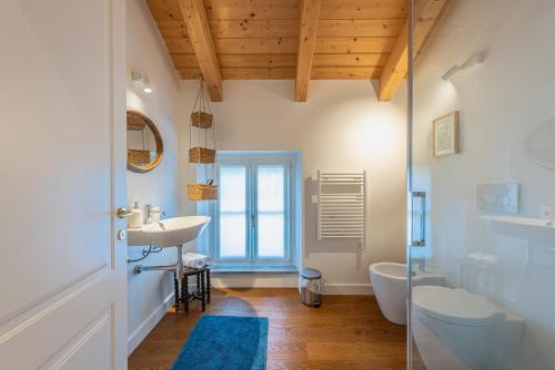 a bathroom with a sink and a tub and a toilet at Casa Rita, Charming House with pool, Asti in Asti
