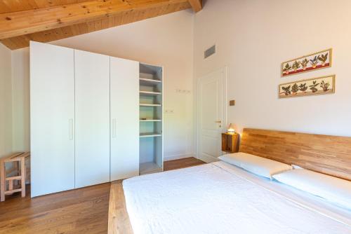 a bedroom with a large bed with a wooden headboard at Casa Rita, Charming House with pool, Asti in Asti