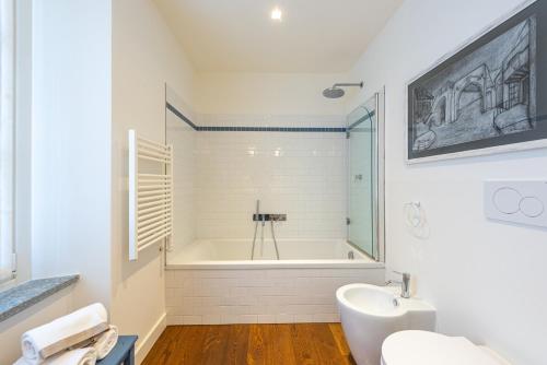 a white bathroom with a tub and a sink at Casa Rita, Charming House with pool, Asti in Asti